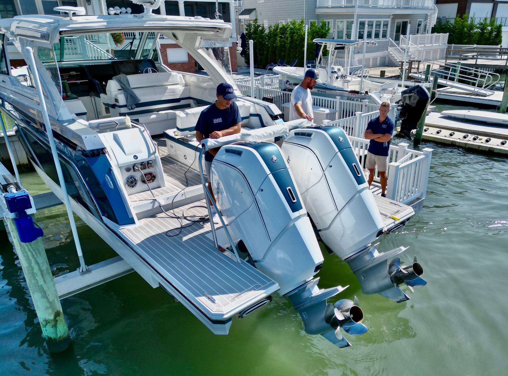 two men working on a boat's propeller