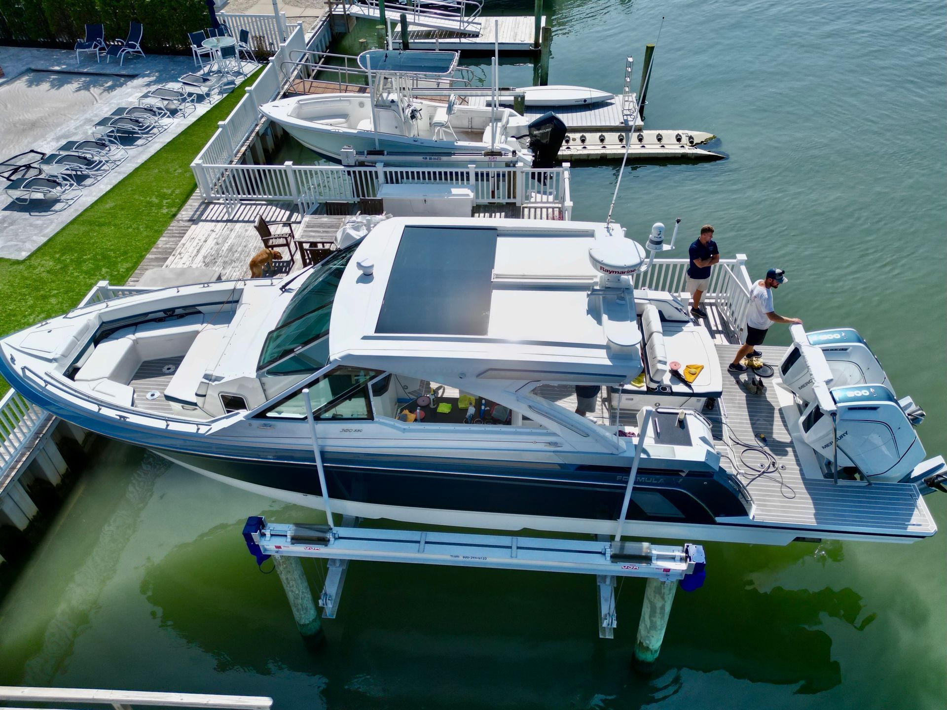 a boat is sitting on a lift in the water