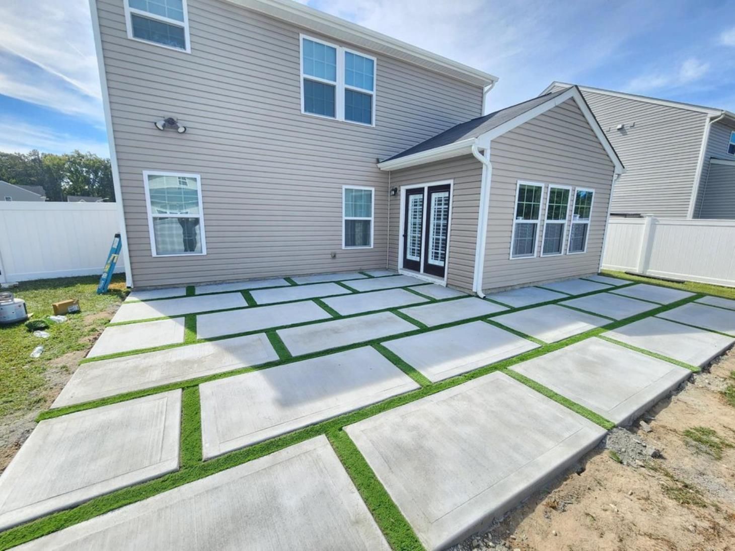 A large house with a patio in front of it.