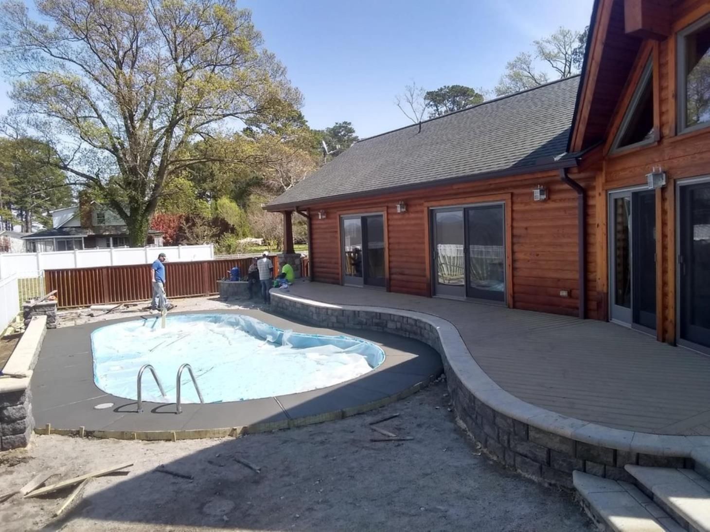 A large house with a large swimming pool in front of it