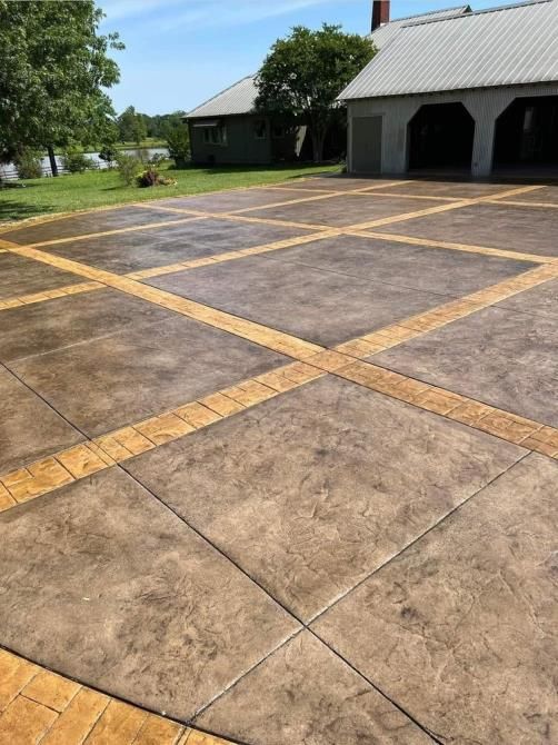 A large concrete driveway with a house in the background.