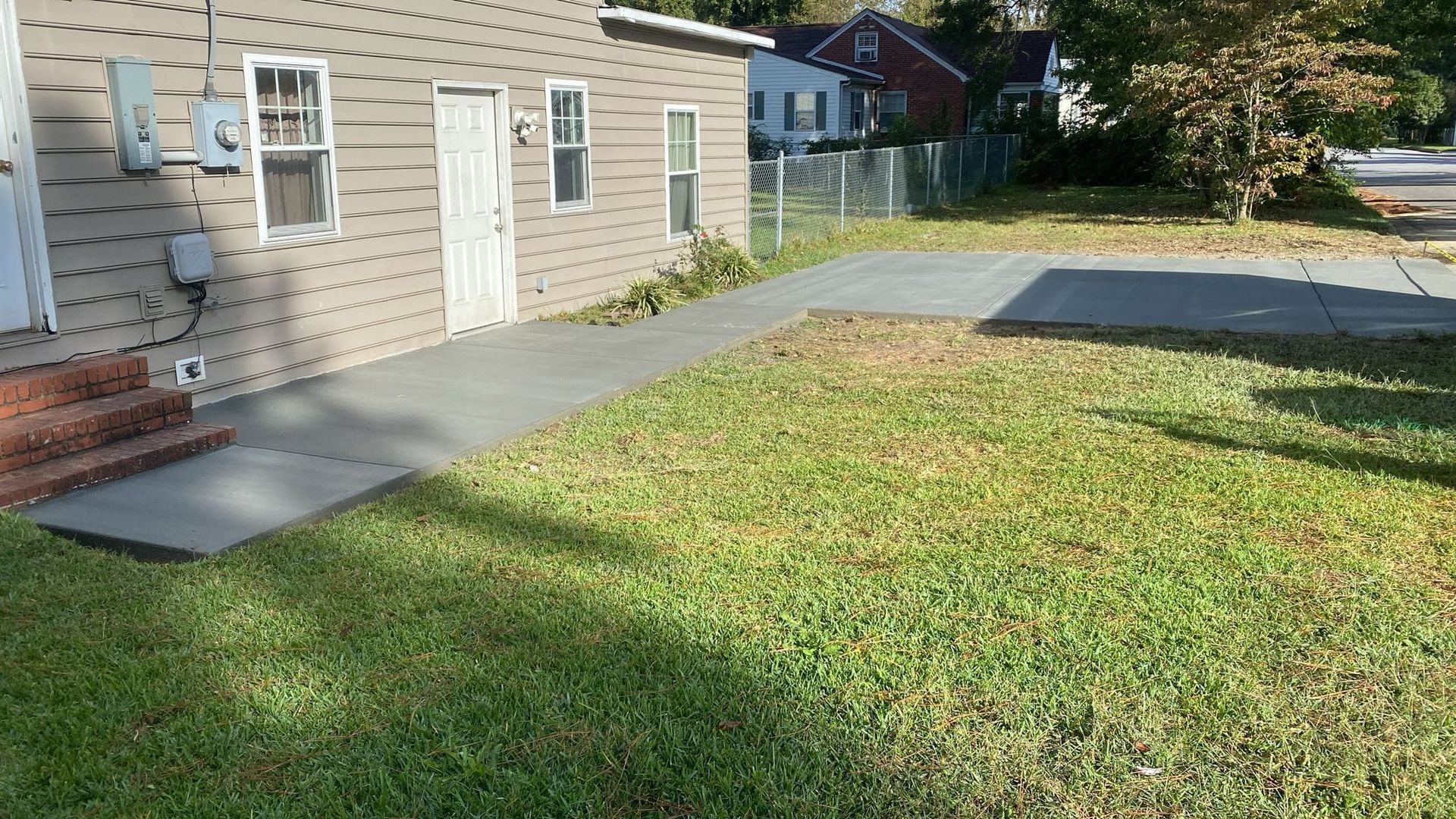 A house with a concrete walkway in front of it