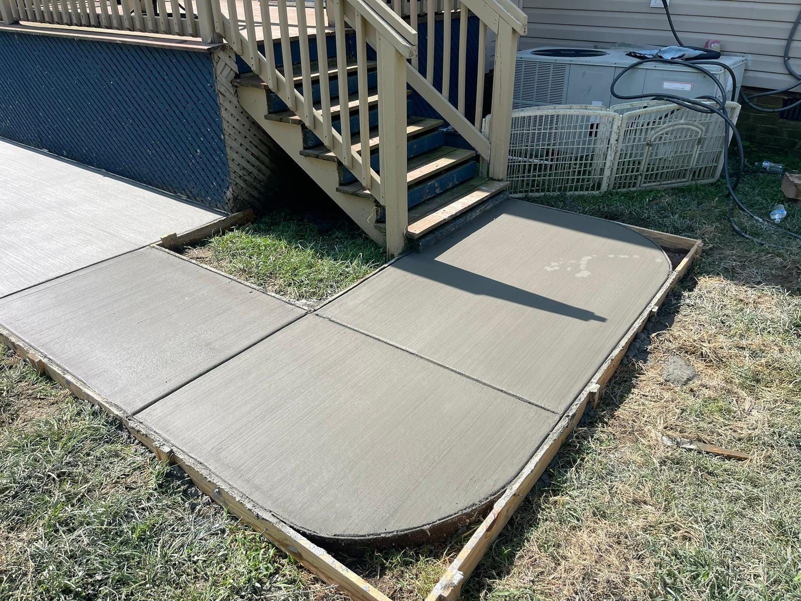 A concrete walkway is being built next to a set of stairs.