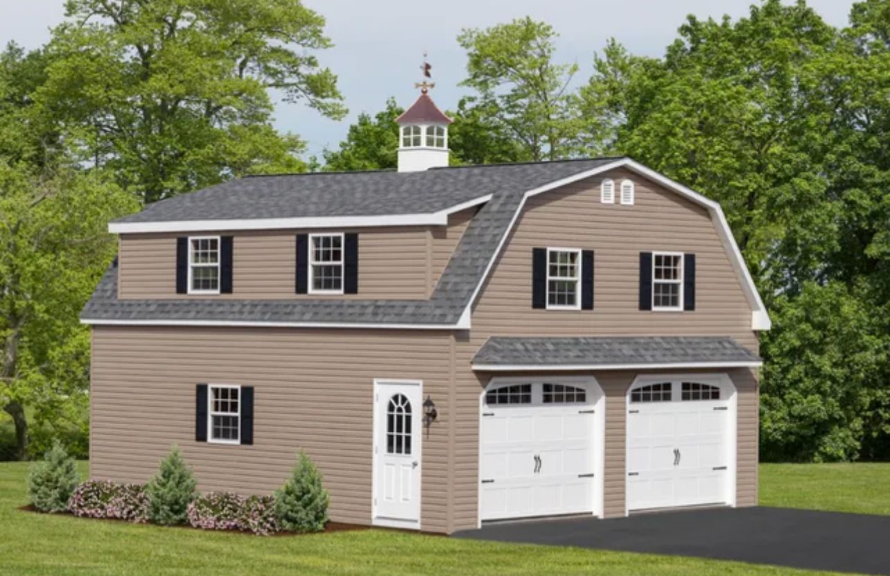 Tan two-story house with white garage doors and black shutters, set in a green yard.