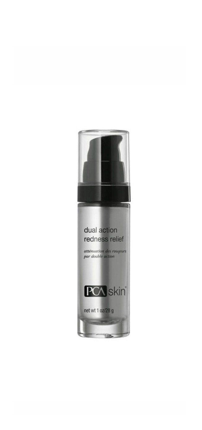 A bottle of foundation is sitting on a white surface.