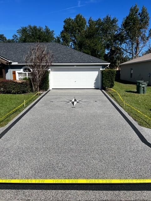 Driveway with fresh gravel, a white garage, and yellow tape at the bottom edge