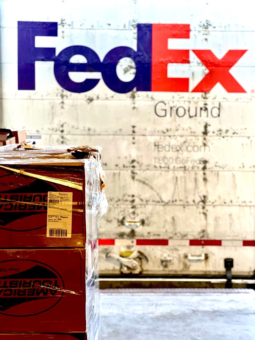 Tan industrial building with rows of windows under a clear blue sky.