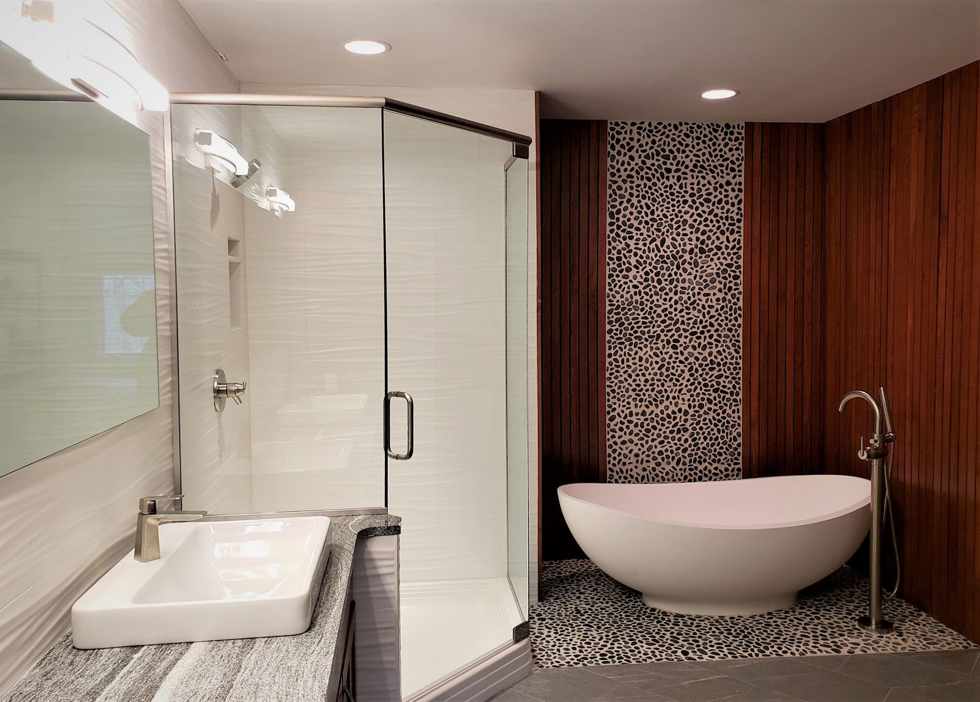 A bathroom with a tub a sink and a shower