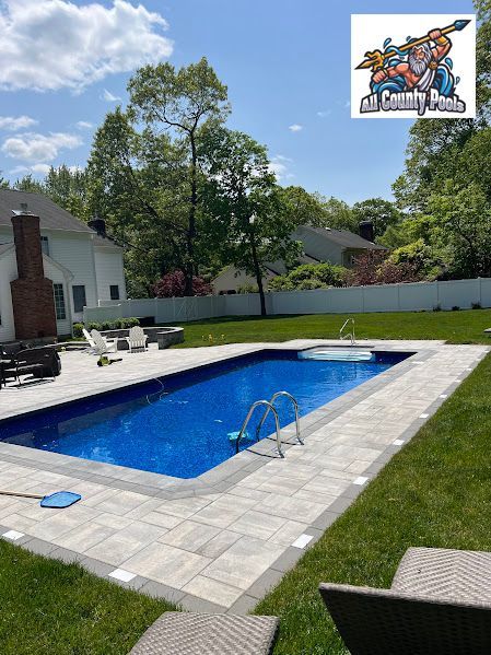 There is a large swimming pool in the backyard of a house.