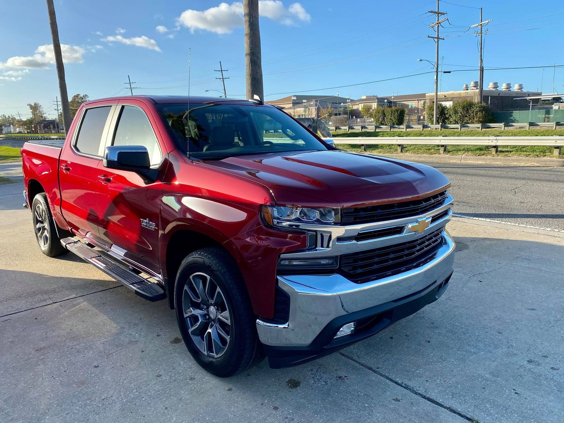 A red truck is parked on the side of the road.