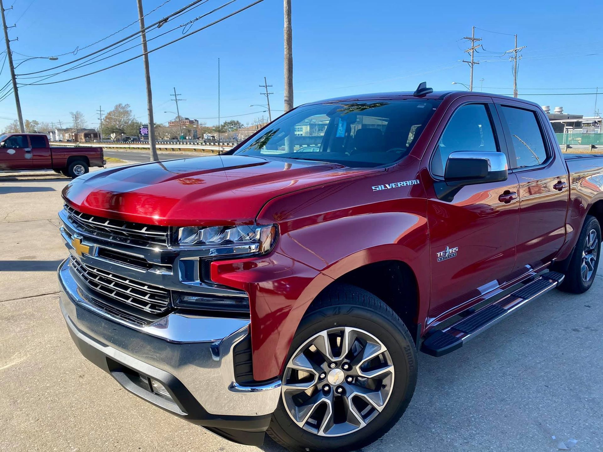 A red truck is parked in a parking lot.