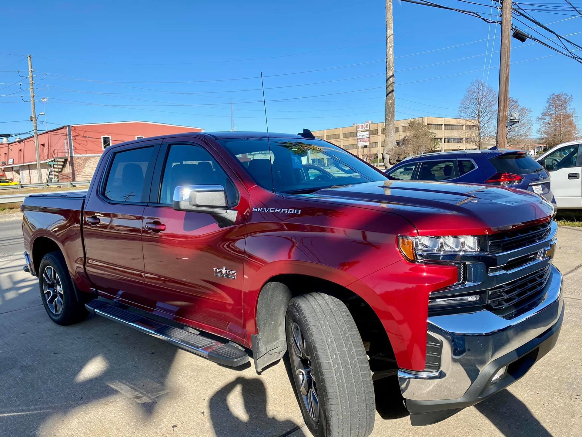 A red pickup truck is parked on the side of the road.