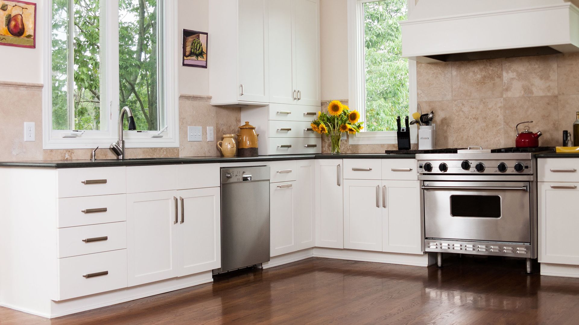 A kitchen with white cabinets and stainless steel appliances