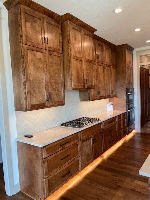 A kitchen with wooden cabinets and a stove top oven
