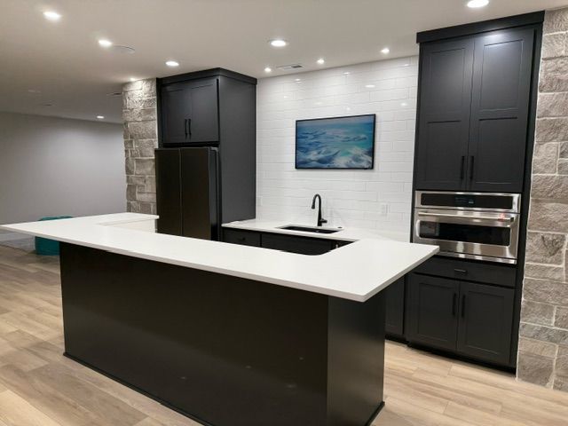 There is a large island in the middle of the kitchen.