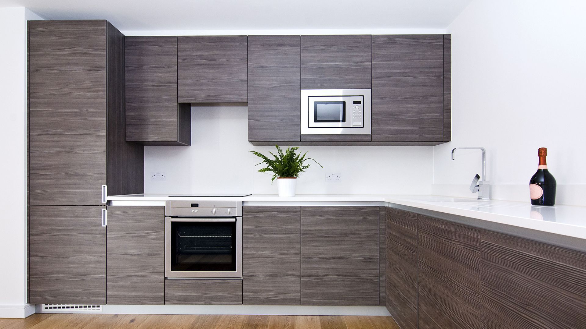 A kitchen with stainless steel appliances and wooden cabinets