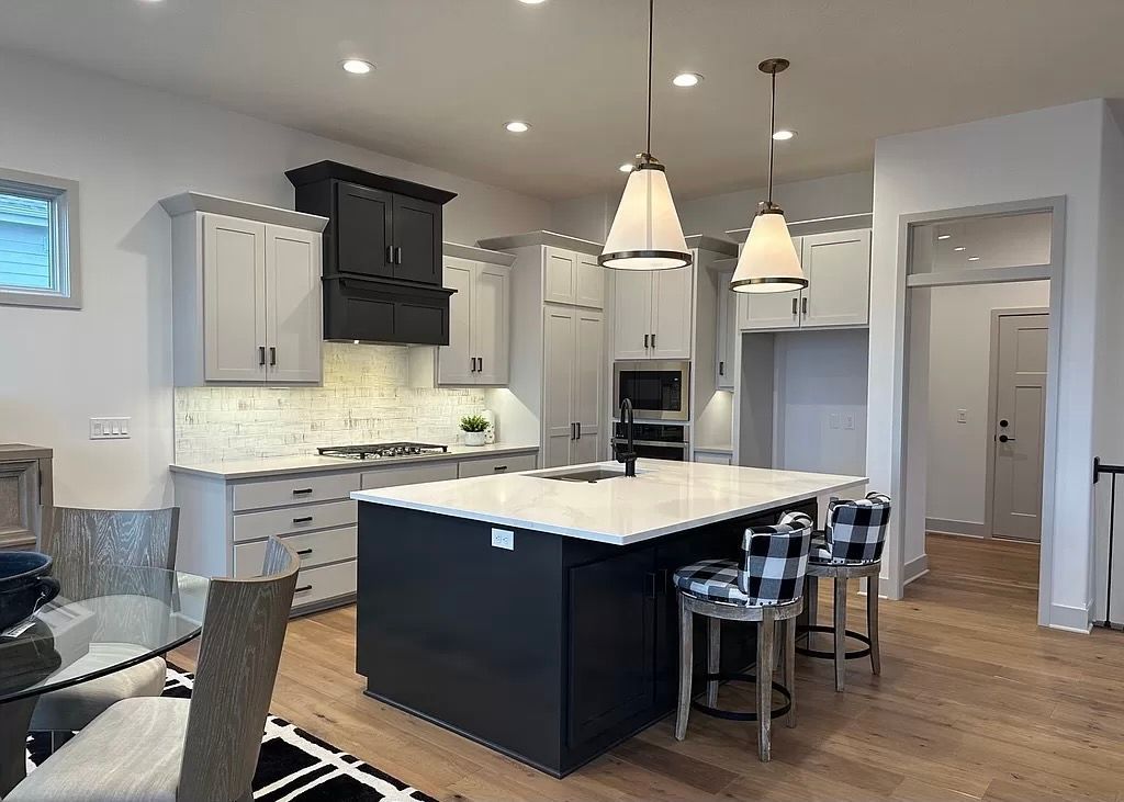 There is a large island in the middle of the kitchen.