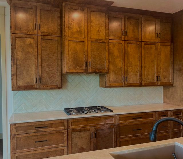 A kitchen with wooden cabinets and a stove top oven