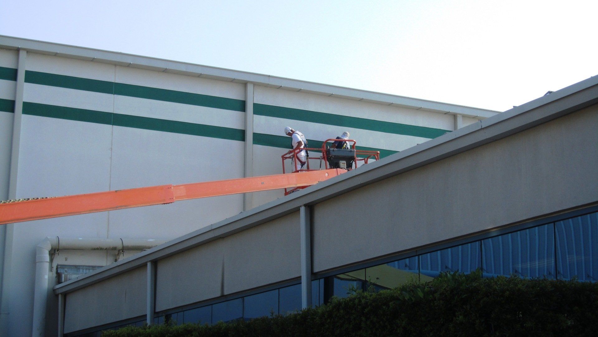 A group of people are working on the side of a building