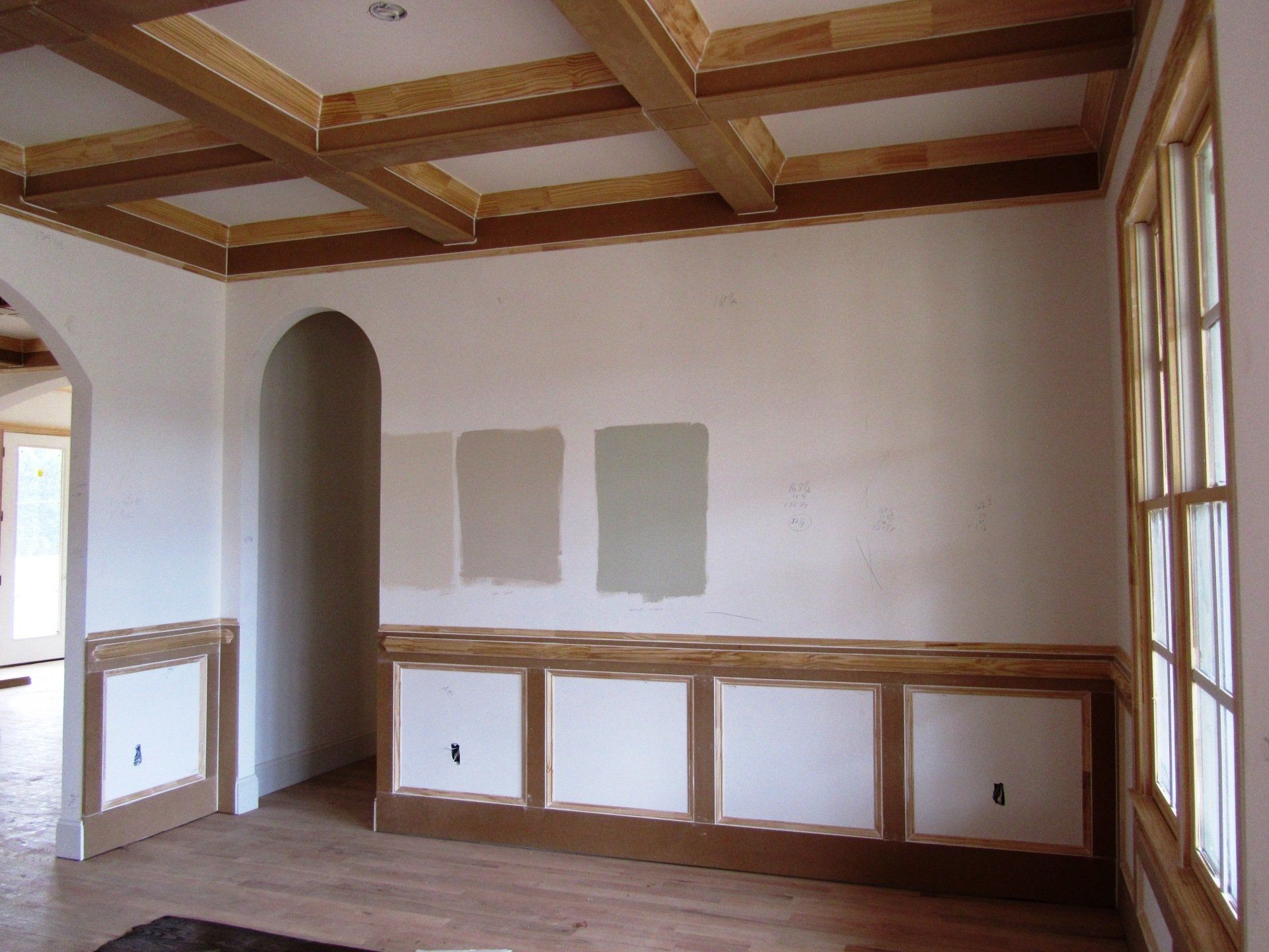 An empty room with a ceiling that has wood beams