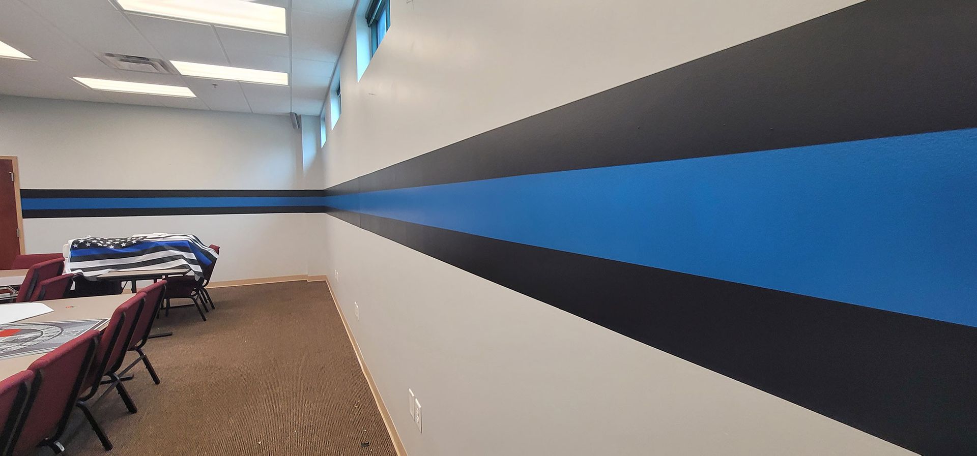 A room with a blue and black stripe on the wall.