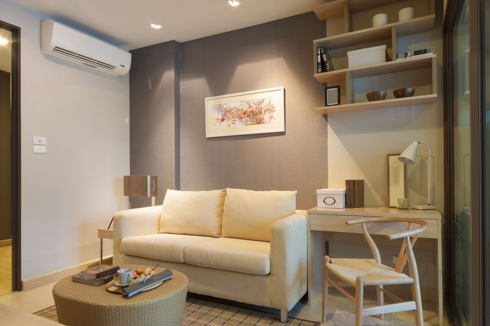 A living room with a couch and a desk