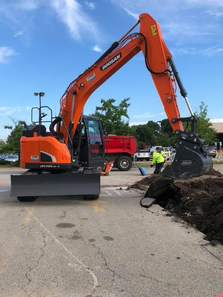 A doosan excavator is digging a hole in the ground