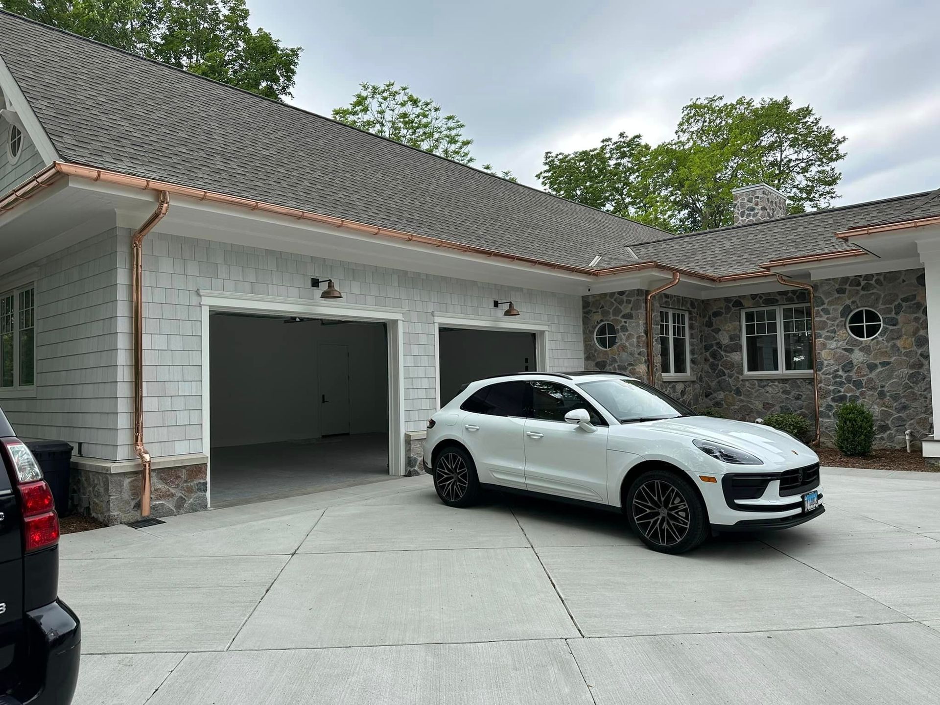 Two-story house with copper gutters.