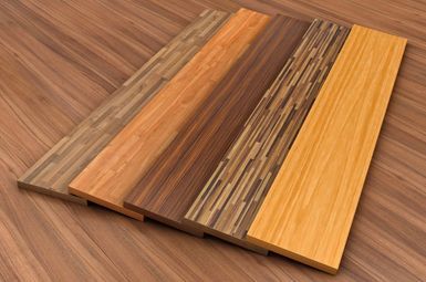 Three pieces of wood are stacked on top of each other on a wooden floor.