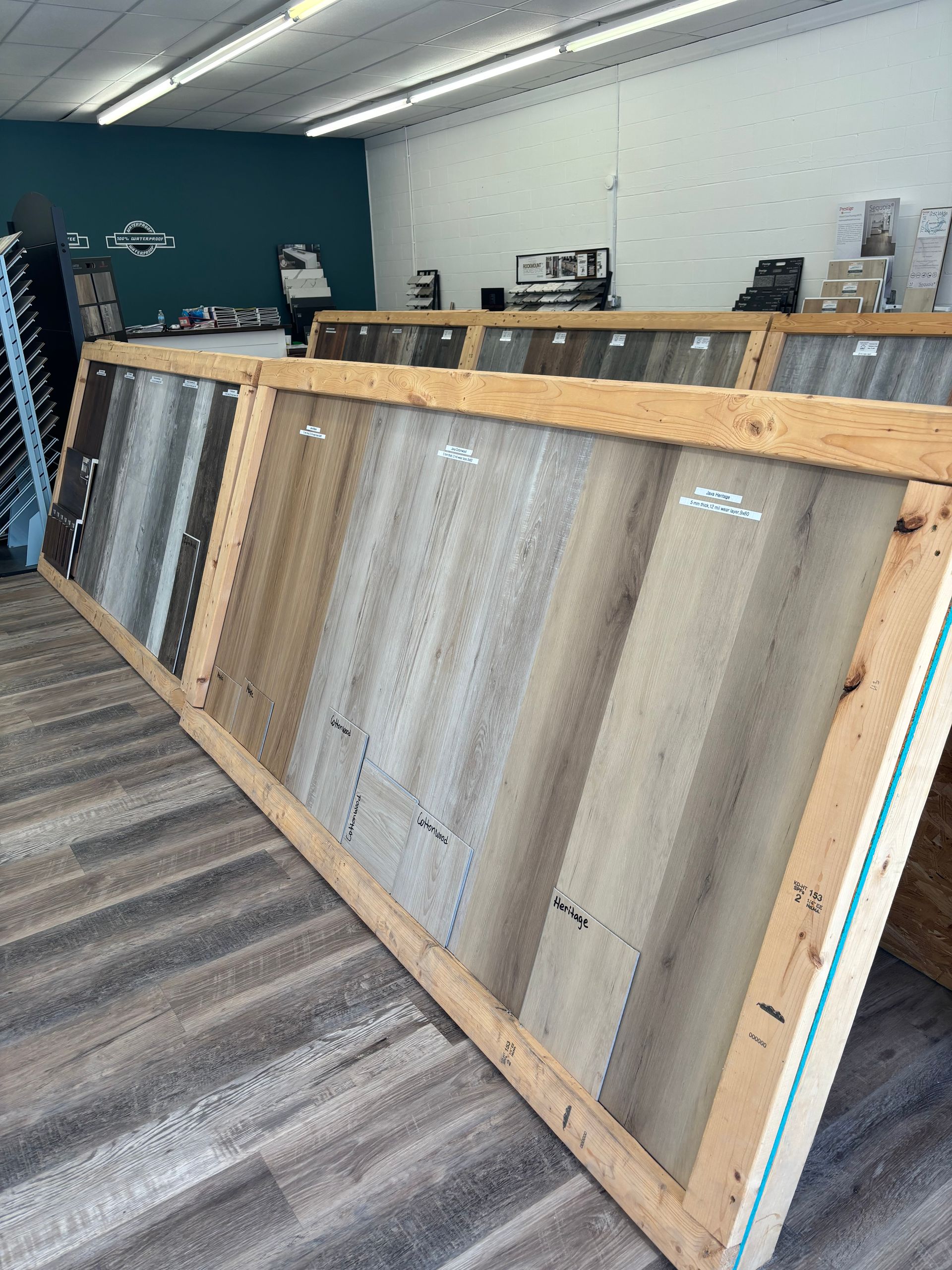 A wooden crate filled with different types of tiles in a store.