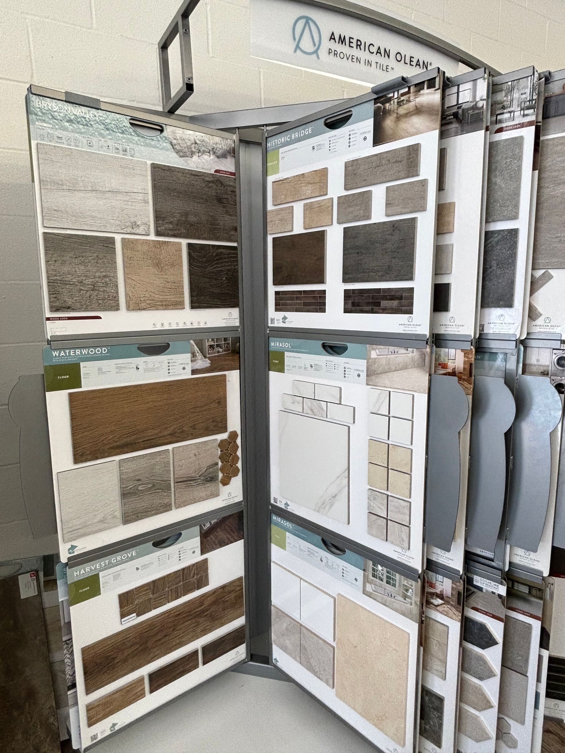 A display case filled with a variety of tiles and carpets.