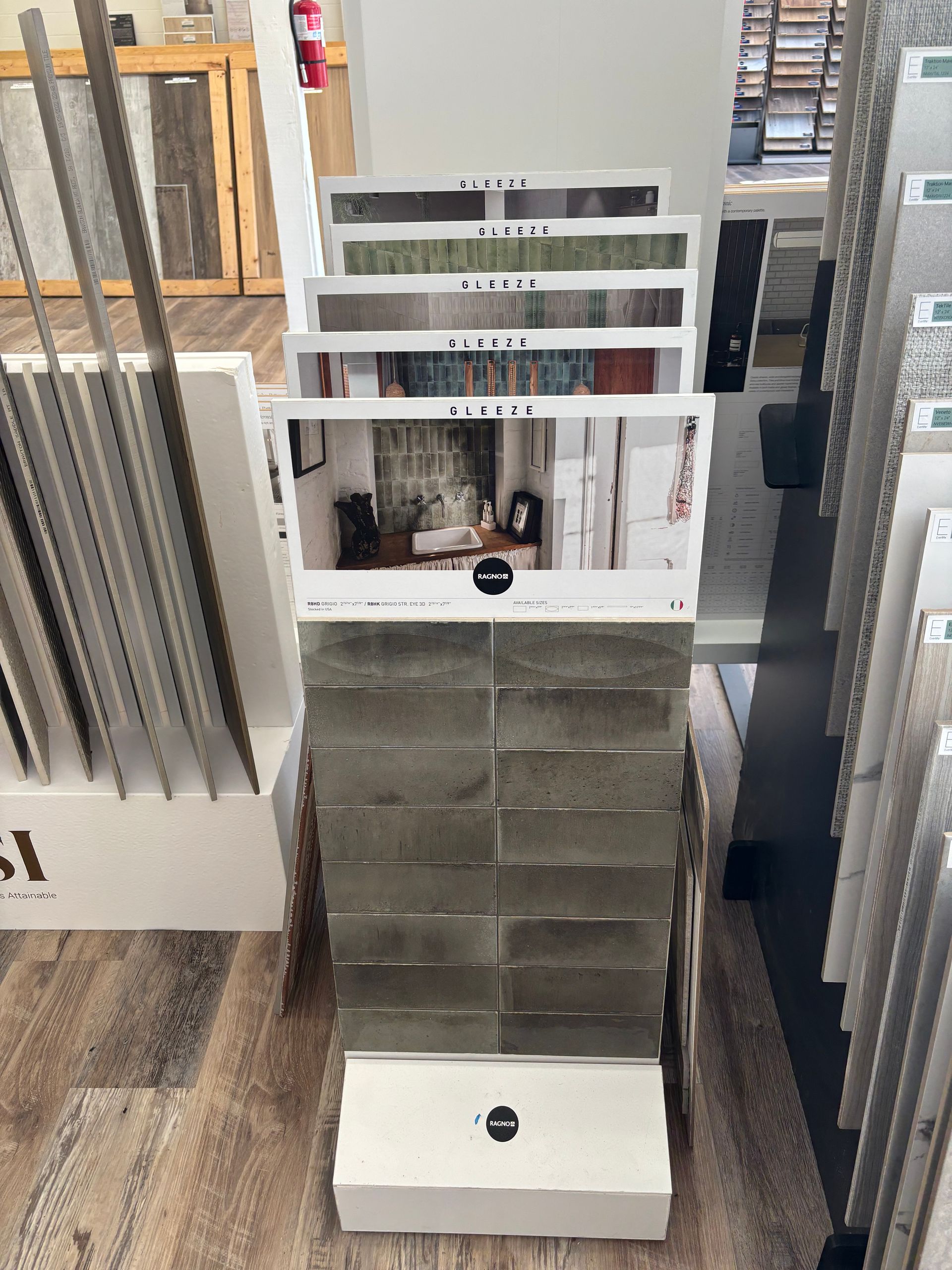 A display of tiles in a store with a picture of a room on it.