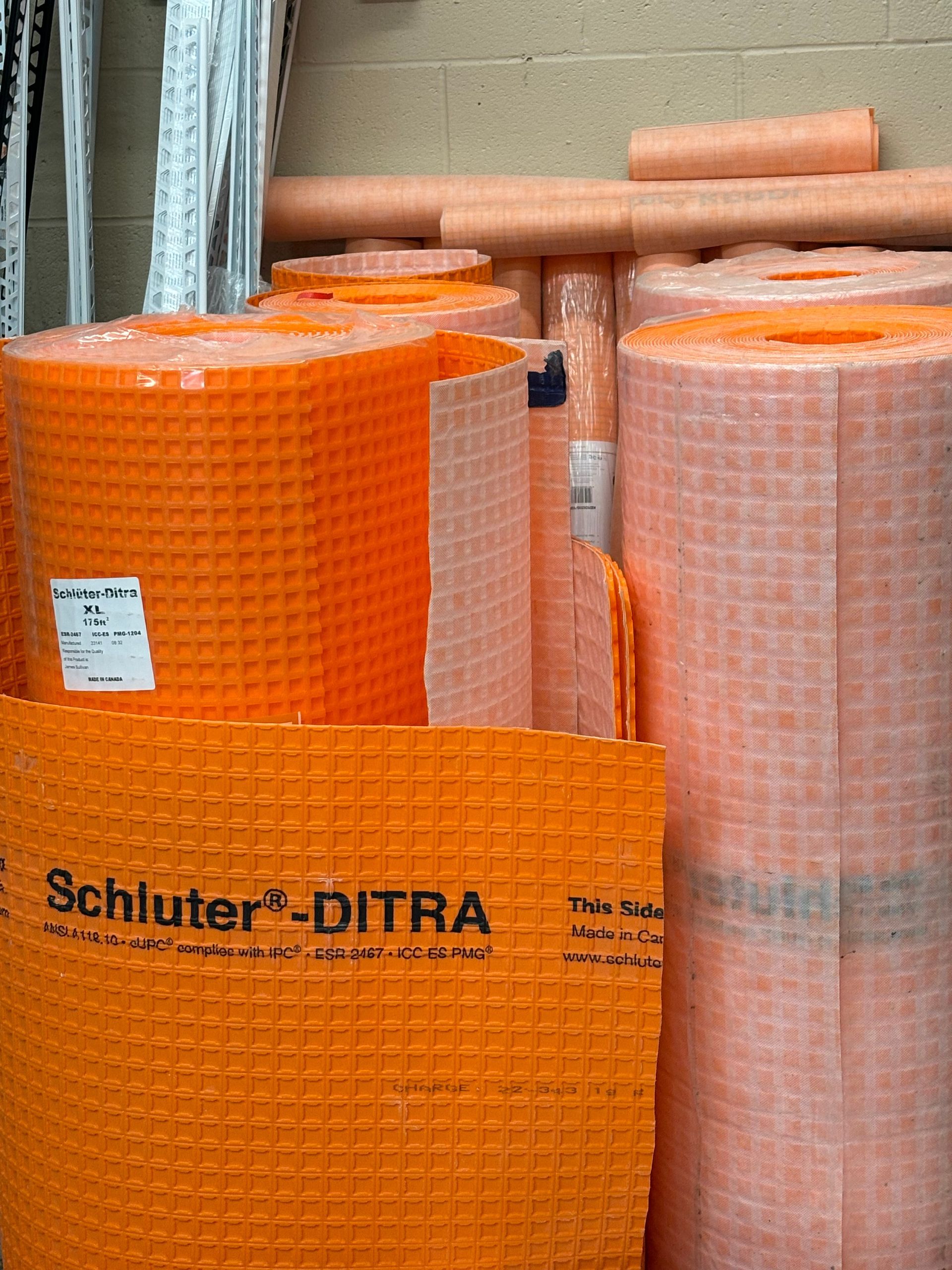 Rolls of Schluter Ditra are stacked on top of each other.