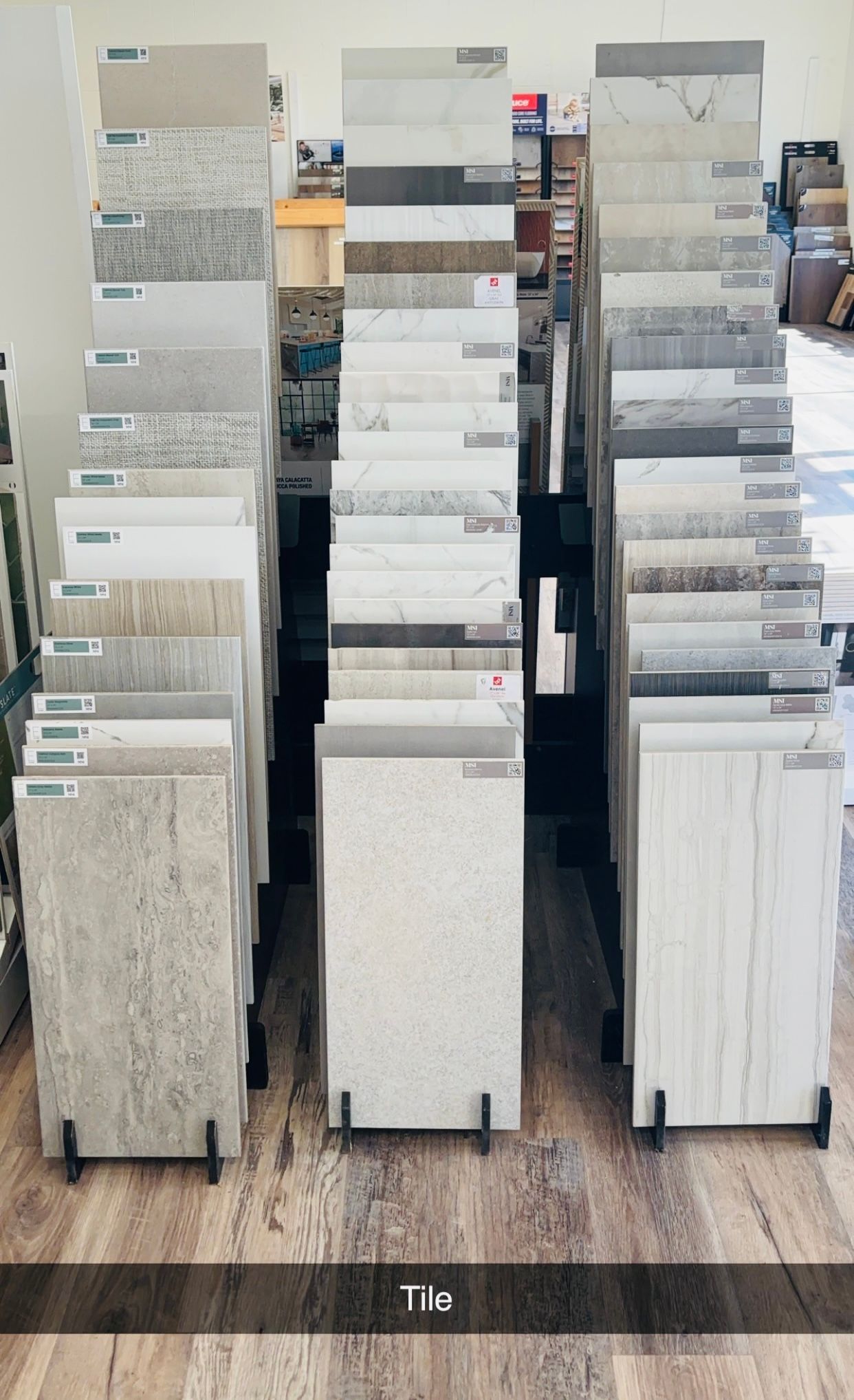 There are many different types of tiles on display in a store.
