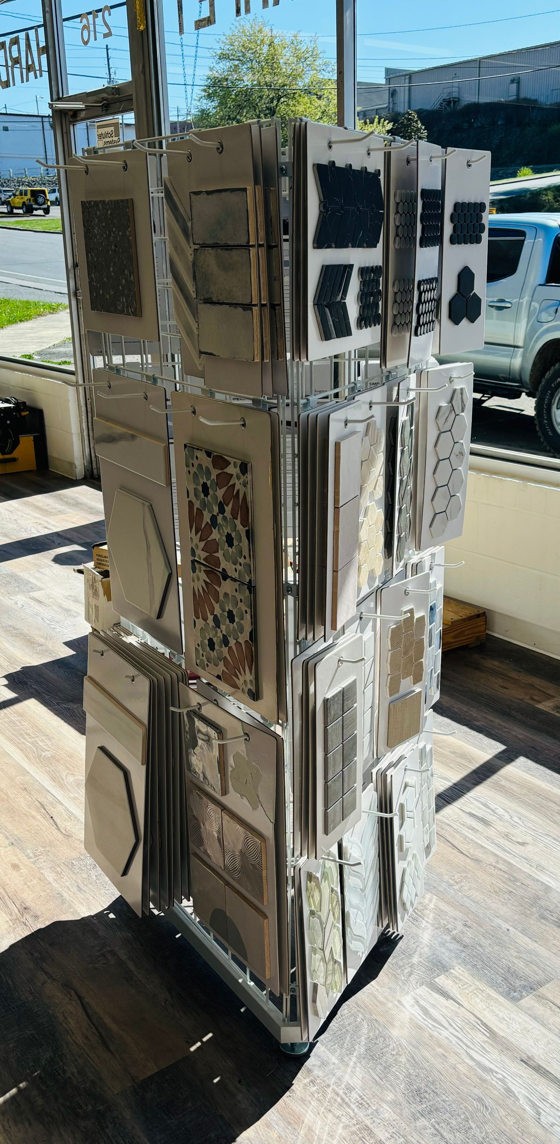 A display of tiles is sitting on a wooden floor.