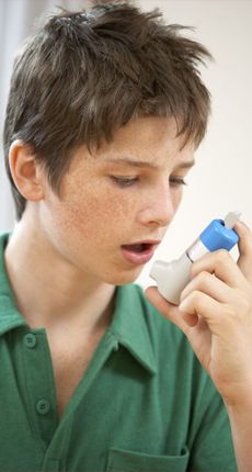 Teenager using inhaler