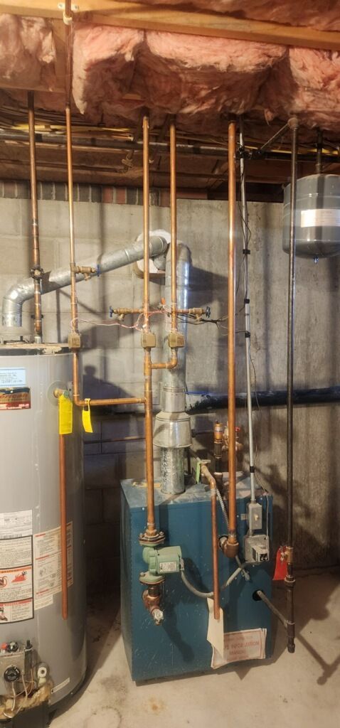 There is a water heater and a boiler in the basement.