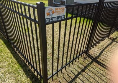 Black metal fence with sign
