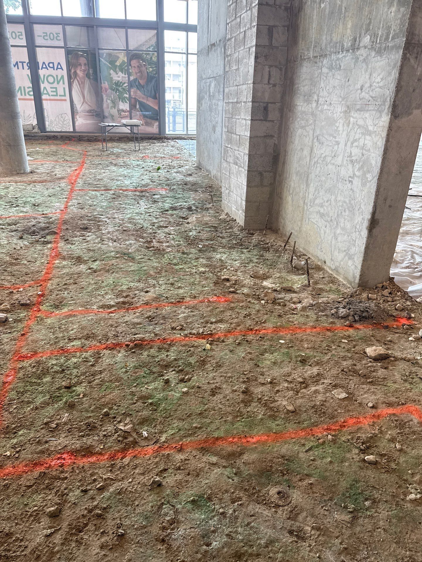 A building under construction with red lines on the floor.