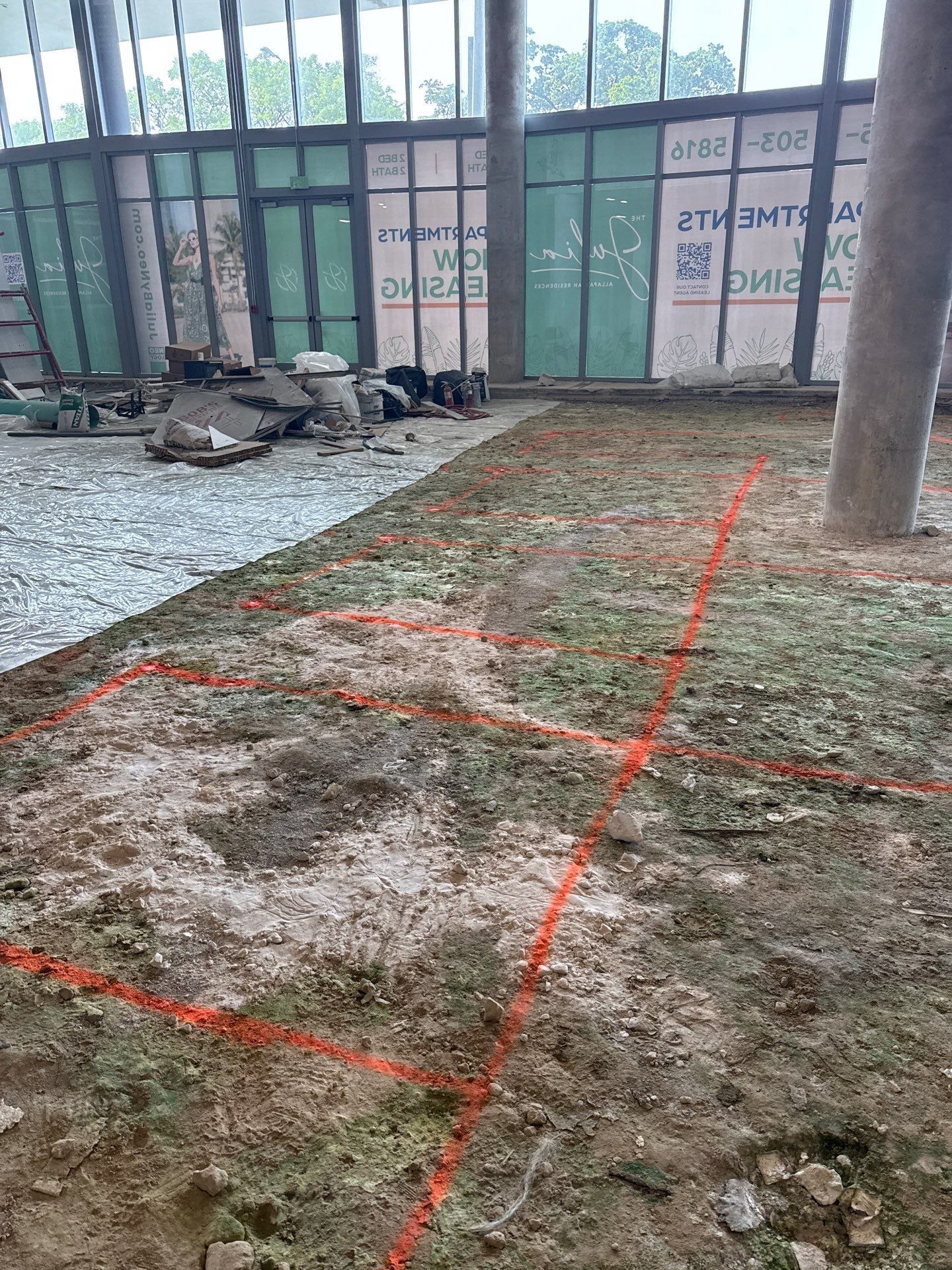 A building under construction with red lines on the ground.