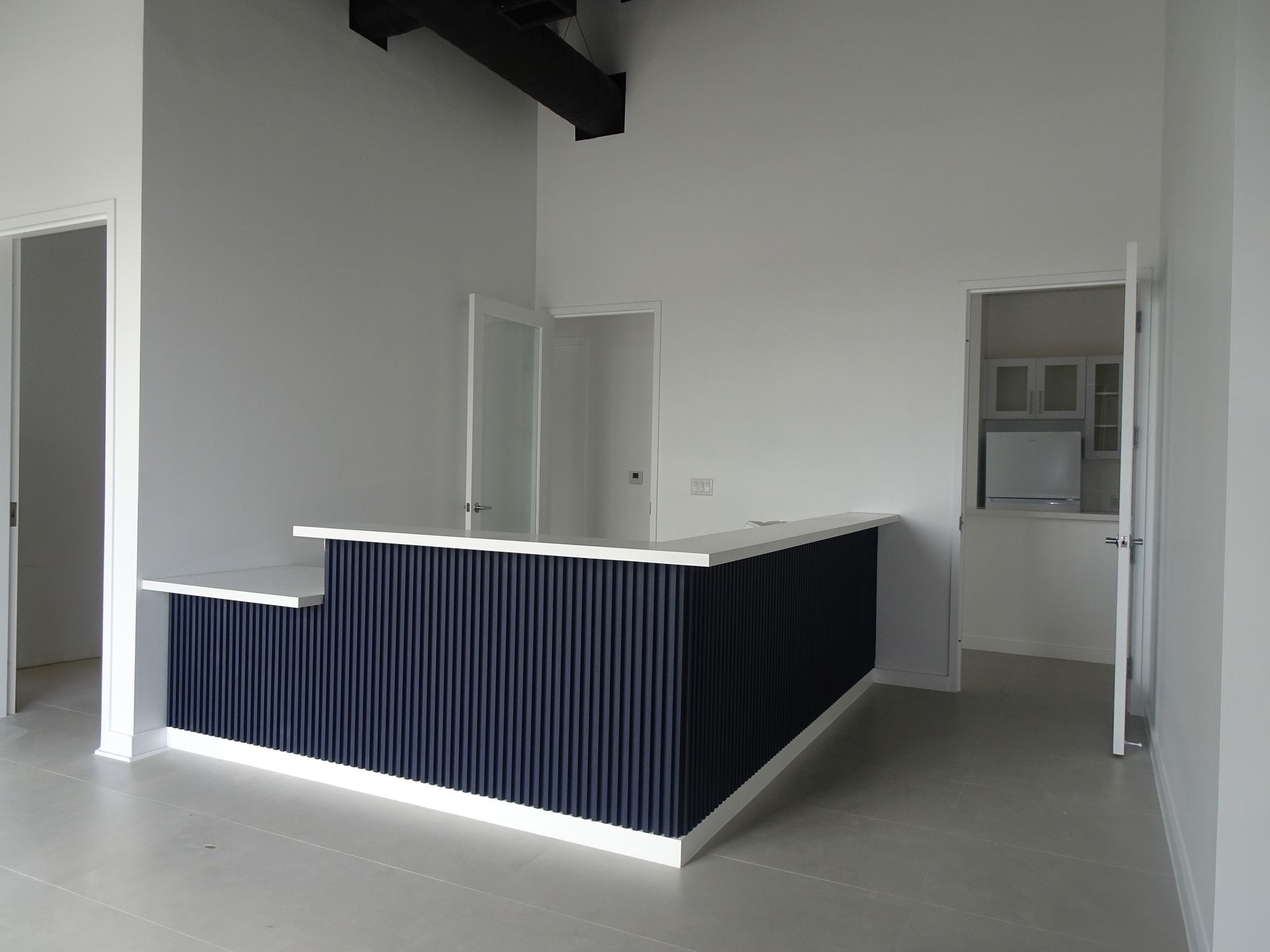 An empty room with a blue counter in the middle