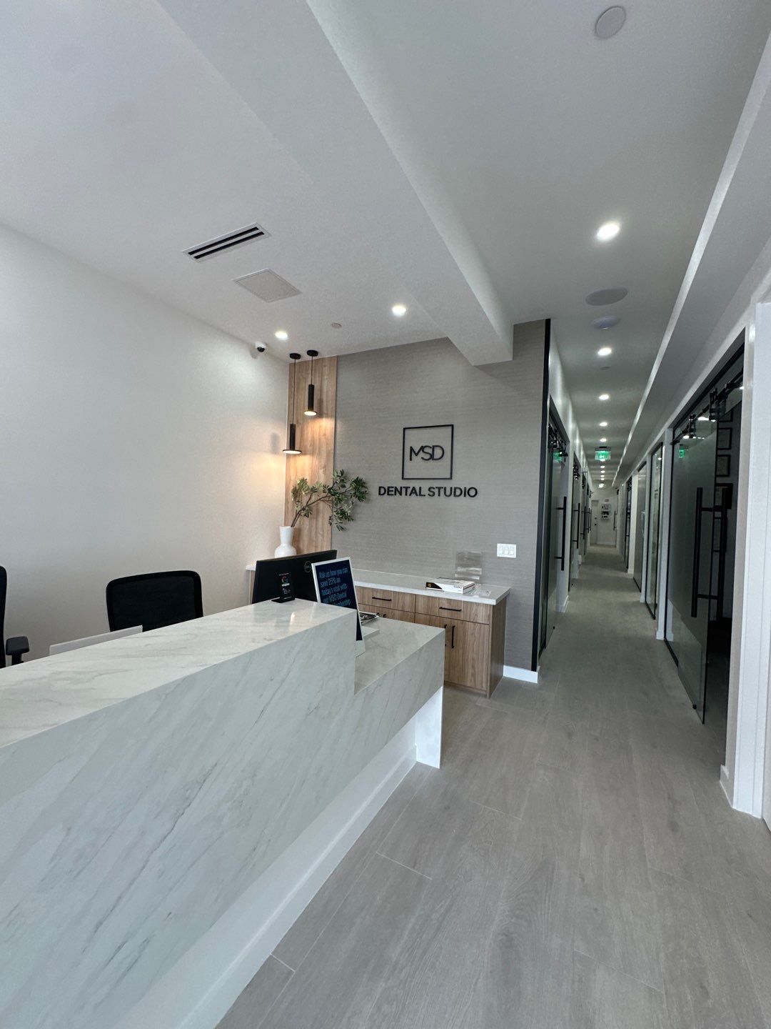 A dental office with a long hallway and a reception desk.
