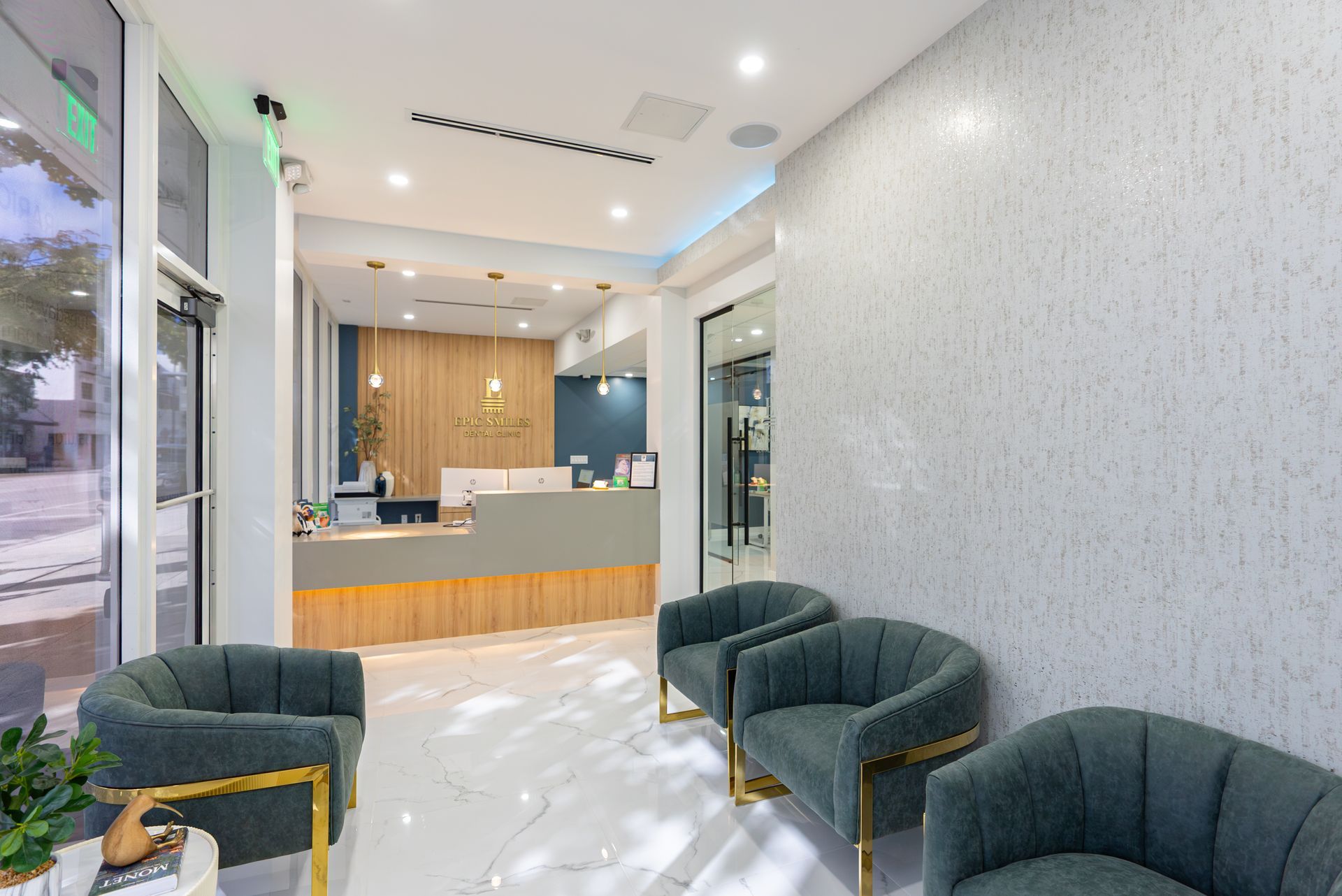 A waiting room with chairs and a counter in a dental office.