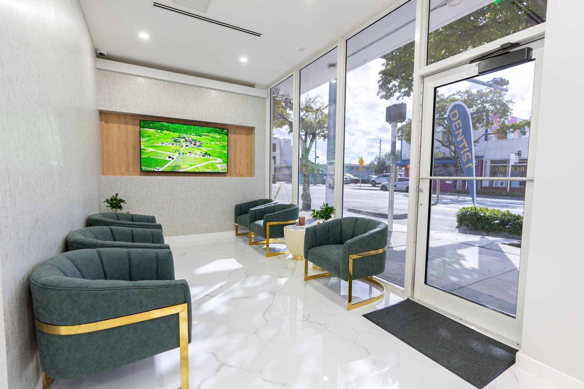 A waiting room with chairs and a television on the wall.