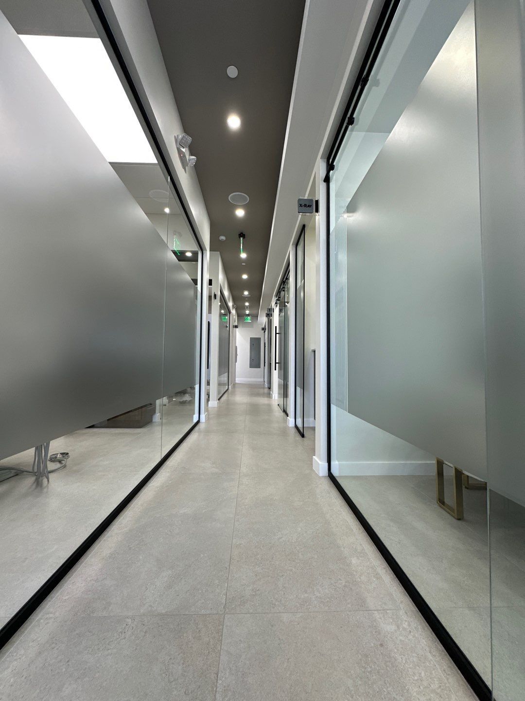 A long hallway with glass walls and a ceiling.