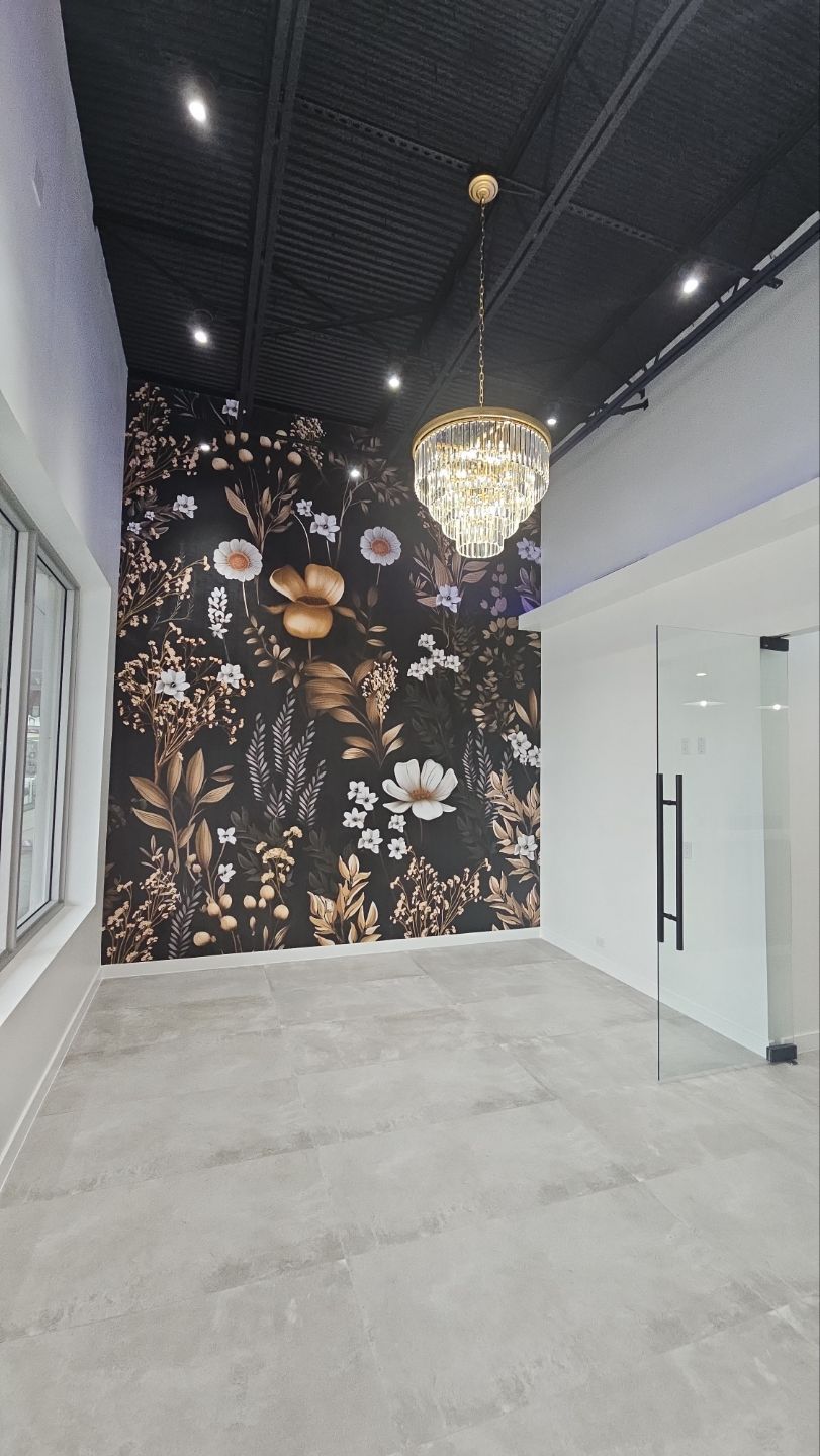 There is a chandelier hanging from the ceiling in the middle of the room.