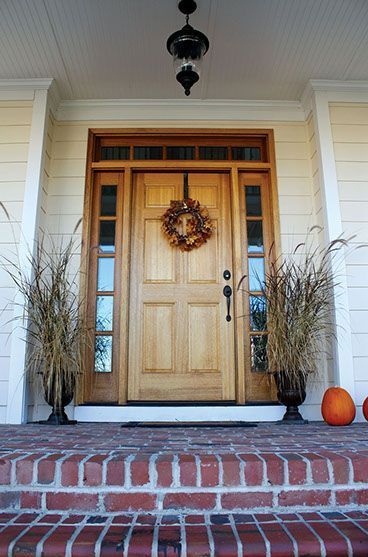 The front door of a house with a wreath hanging from it