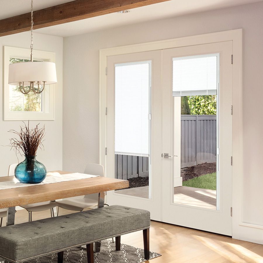A dining room with a table and chairs and a bench