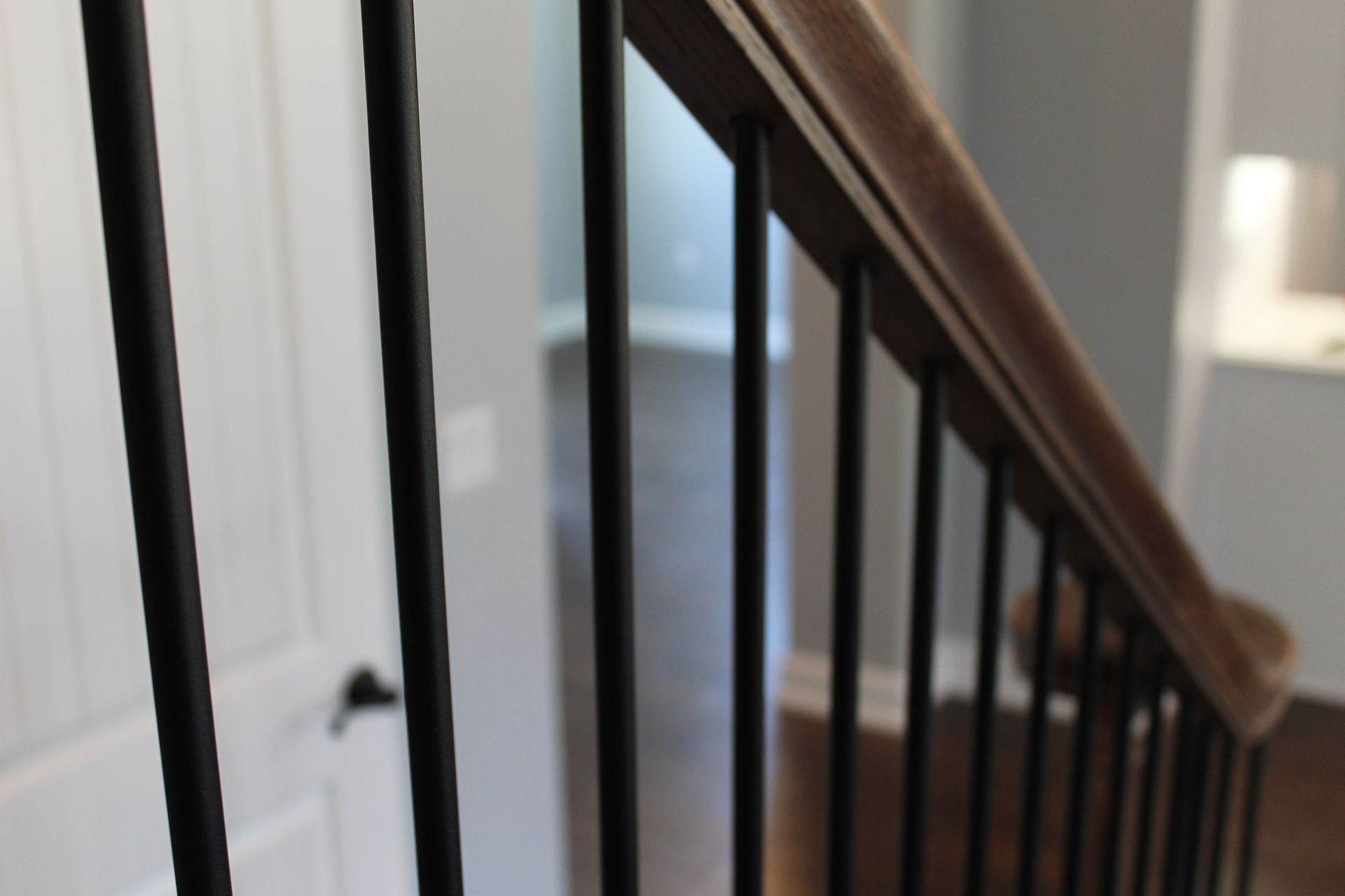 A close up of a black railing on a staircase