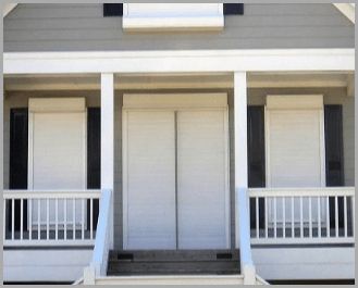 A house with a porch and two white doors